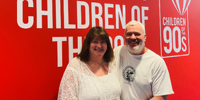 Photo of a woman and man smiling at the camera 